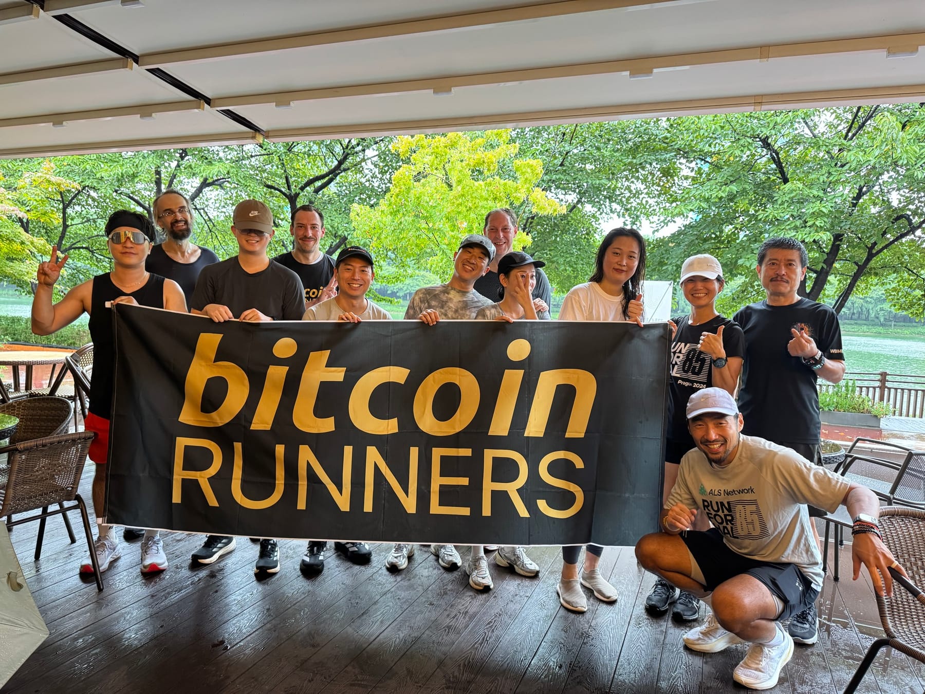 Bitcoin Runners group holding the club banner at a community run in Seoul